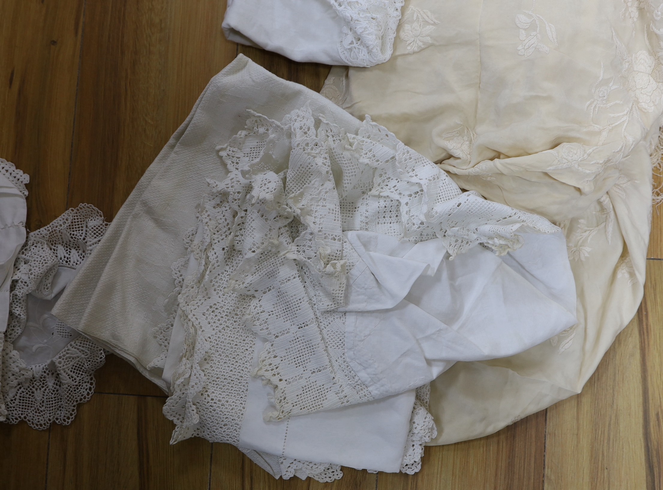 A late 19th century Chinese cream silk embroidered shawl, a tape lace bed cover and a collection of smaller cloths with crochet edges